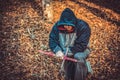 A man is kneeling in prayer, holding a Catholic cross in his hand, bowing his head in prayer to God Royalty Free Stock Photo