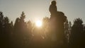 Man kneeling by pregnant partner at sunset