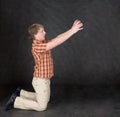 Man is kneeling and stretch hands to something