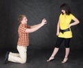 Man is kneeling to the young woman