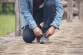 Man kneels down rope tie shoes industry boots for worker. Close up shot of man hands tied shoestring for his brown construction Royalty Free Stock Photo