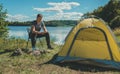 Man with knife near camping tent Royalty Free Stock Photo