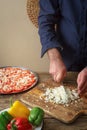 Man knife sliced onion pizza on a cutting board Royalty Free Stock Photo