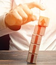 A man knocks down a tower of blocks with an up arrow. End of career, destruction of progress and achievements. Sabotage. Eliminate Royalty Free Stock Photo