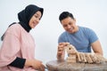 Man knocks down wooden blocks that have been arranged