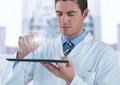 Man in lab coat with device and white graph with flare against blurry building Royalty Free Stock Photo