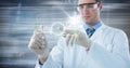 Man in lab coat and goggles with glass device and white interface against motion blur Royalty Free Stock Photo