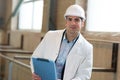 Man in lab coat and helmet in factory Royalty Free Stock Photo