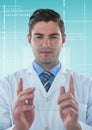 Man in lab coat holding up glass device against white interface and blue background Royalty Free Stock Photo