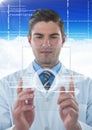 Man in lab coat holding up glass device with white interface against blue sky with cloud Royalty Free Stock Photo