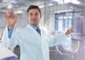 Man in lab coat pointing with flare against white interface and blurry lab Royalty Free Stock Photo