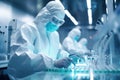 A man in a laboratory suit is standing in a sterile room with a microscope