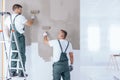 Man on ladder painting wall Royalty Free Stock Photo