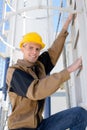 Man ladder poised to climb enclosed ladder