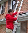 Man on Ladder on a roof Royalty Free Stock Photo