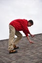 Man on Ladder on a roof Royalty Free Stock Photo