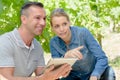 Man and lady in grapevines holding tablet
