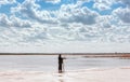 Man By The Lake Among Quartz Sand Under Beautiful Cloudy Sky