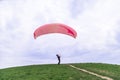 Man landed and tries to drop parachute on ground