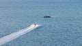 Man landing a waverunner jetski on a floating dock