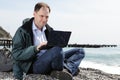 Man with laptop on beach Royalty Free Stock Photo