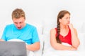 Man with a laptop and a frustrated wife