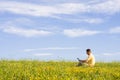 Man with laptop on meadow Royalty Free Stock Photo