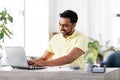 Man with laptop and papers working at home Royalty Free Stock Photo