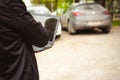 Professional man with a laptop in car tunes tuning control system Royalty Free Stock Photo