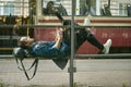 Man with laptop on public transport stop