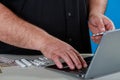 Man ordering drugs or supplements from an internet pharmacy a laptop researching about the drugs or buying from an online pharmacy