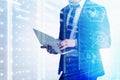 Man with laptop in server room, cyber security Royalty Free Stock Photo