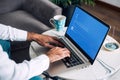 Man with laptop showing Blue screen of death or BSOD on the monitor screen.