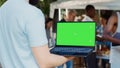 Man with laptop showing green screen