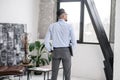 Man with laptop standing with back to camera Royalty Free Stock Photo