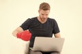 Man with laptop wear boxing glove isolated on white. Bearded man use computer for internet game. Sport bets and gambling