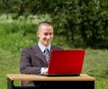 Man with laptop working outdoors Royalty Free Stock Photo