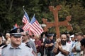 A man with a large Orthodox cross and a policeman Royalty Free Stock Photo