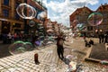 Man launches soap bubbles entertain tourists in the old city cen Royalty Free Stock Photo