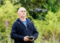 A man launching a drone on meadow