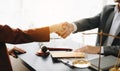 Man lawyer hand and women client shaking hand collaborate on working agreements with contract documents at the modern office Royalty Free Stock Photo