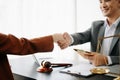 Man lawyer hand and women client shaking hand collaborate on working agreements with contract documents at the modern office Royalty Free Stock Photo