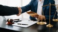 Man lawyer hand and women client shaking hand collaborate on working agreements with contract documents at the modern office Royalty Free Stock Photo