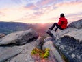 . Man lay on summit, bellow autumn valley. Bright morning Sun shining in sky.