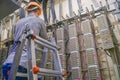 The man is laying the cable in the server room of the data center. The engineer standing on the stairs works with the switching Royalty Free Stock Photo