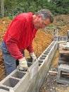 Man laying concrete block wall