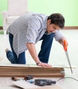 Man laying flooring at home Royalty Free Stock Photo