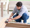 Man laying flooring at home Royalty Free Stock Photo