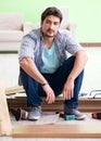 Man laying flooring at home