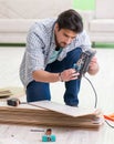 Man laying flooring at home